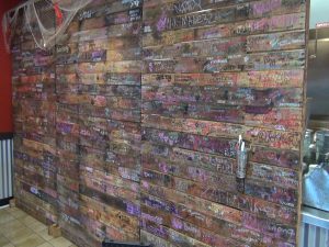 Wall with customers' names and signatures at Da Shrimp Hale in Kahului. Photo by Kiaora Bohlool.