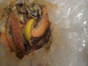 Shrimp and other seafood, steamed in a bag and delivered to a table at Da Shrimp Hale in Kahului. Photo by Kiaora Bohlool.