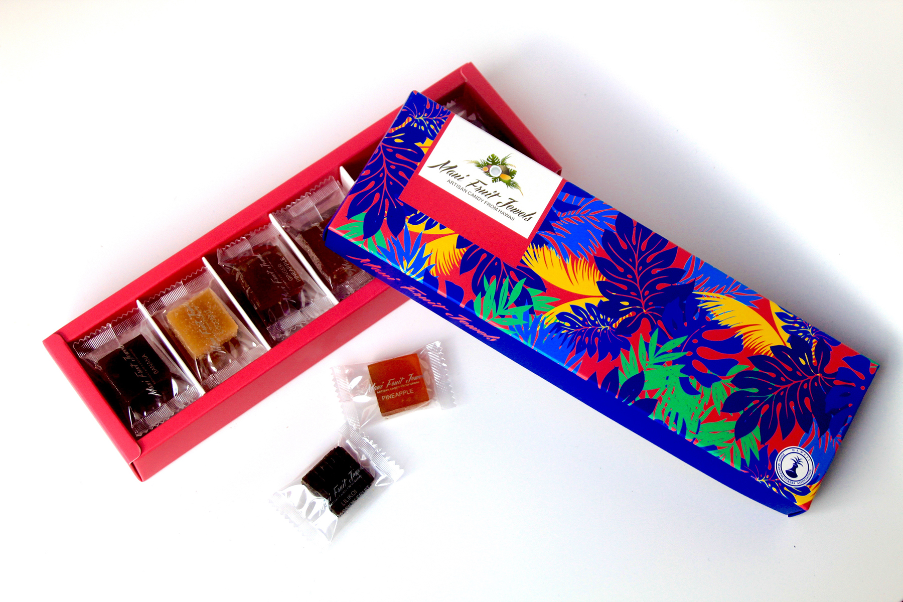 Maui Fruit Jewel’s Lahaina Collection is a gift-quality presentation box filled with a comprehensive assortment of fruit, spice, wine, and herb-flavored candies, including 18 flavors.