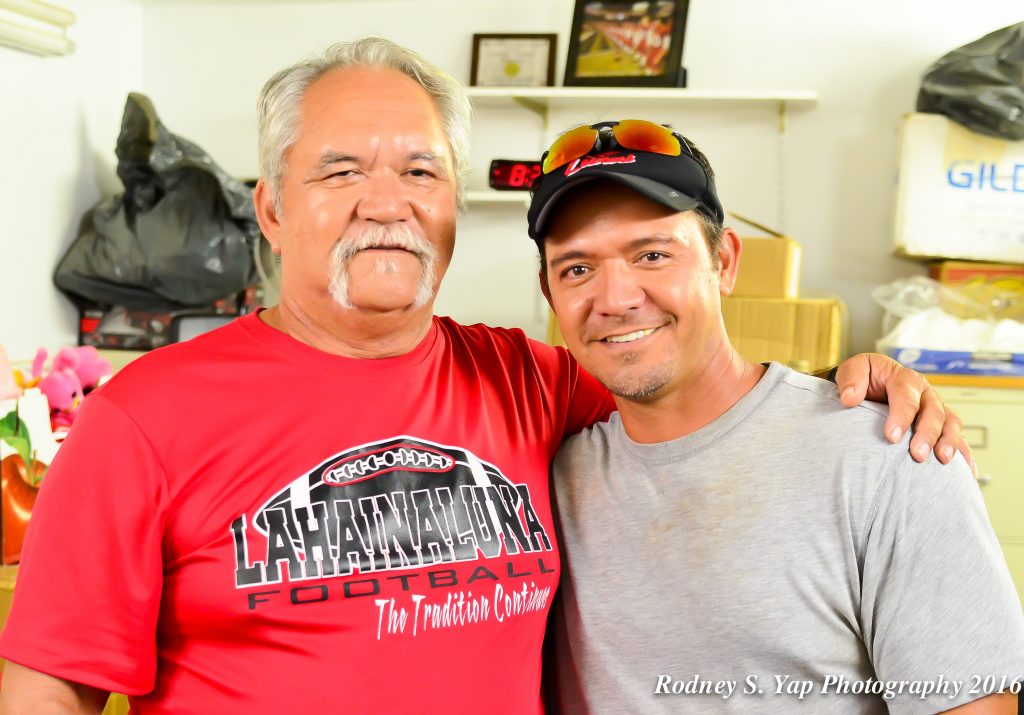 Lahainaluna football coaches Bobby Watson (right) and son Kenui Watson. The coaches help guide Lahainaluna to its first-ever state Division II championship, and talked about the historical journey with MauiNow.com last week. Photo by Rodney S. Yap.