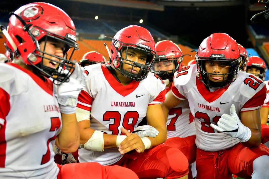 Some of the Lahainaluna players prepare for the trophy celebration after the Lunas defeated Kapaa for the state Division II football championship. Photo by Glen Pascual.