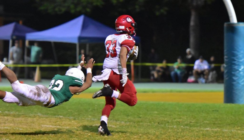 Lahainaluna's Joshua Tihada escapes Konawaena's last would-be tackler en route to a 43-yard touchdown run in the fourth quarter. Photo by Glen Pascual.