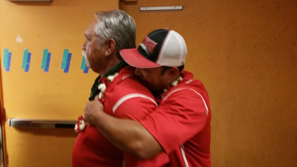 The Watsons, coach Bobby gets a hug from his son Kenui, following the team's D-II state championship victory against Kapaa at Aloha Stadium. Photo by Glen Pascual.
