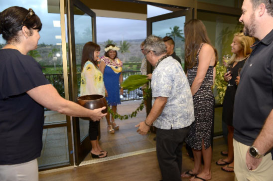 Kahu Alika performed a ceremony of the newly christened space. Riette Jenkins, an Elite Pacific Partner and Broker-Realtor, stands outside, ready to greet the kahu ont eh other side of the maile lei.