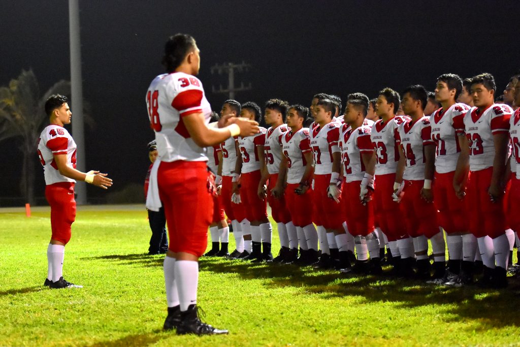 The Lahainaluna football team sings the school's alma mater prior to playing the Wildcats at Konawaena. Photo by Glen Pascual.