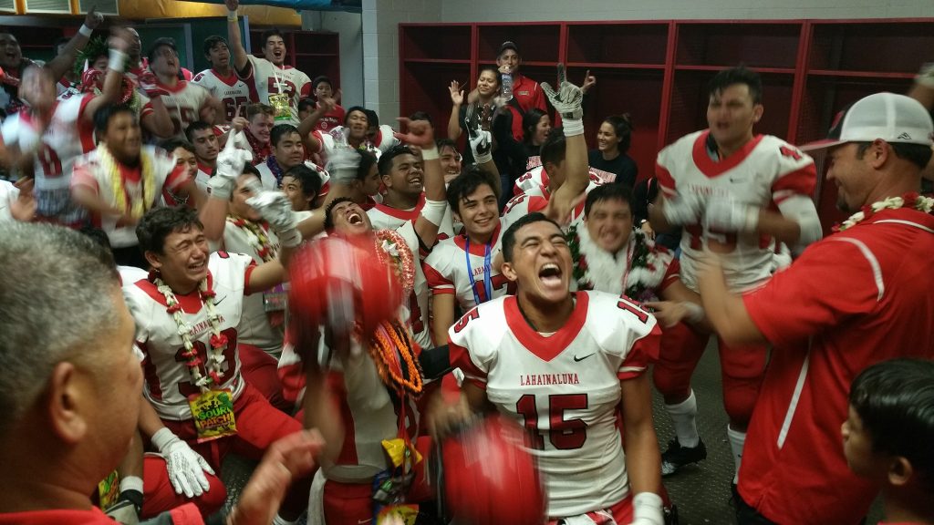 The Lunas celebrate in their locker room at Aloha Stadium Friday after claiming the state Division II football championship over Kapaa, 21-14. Photo courtesy of Glen Pascual.