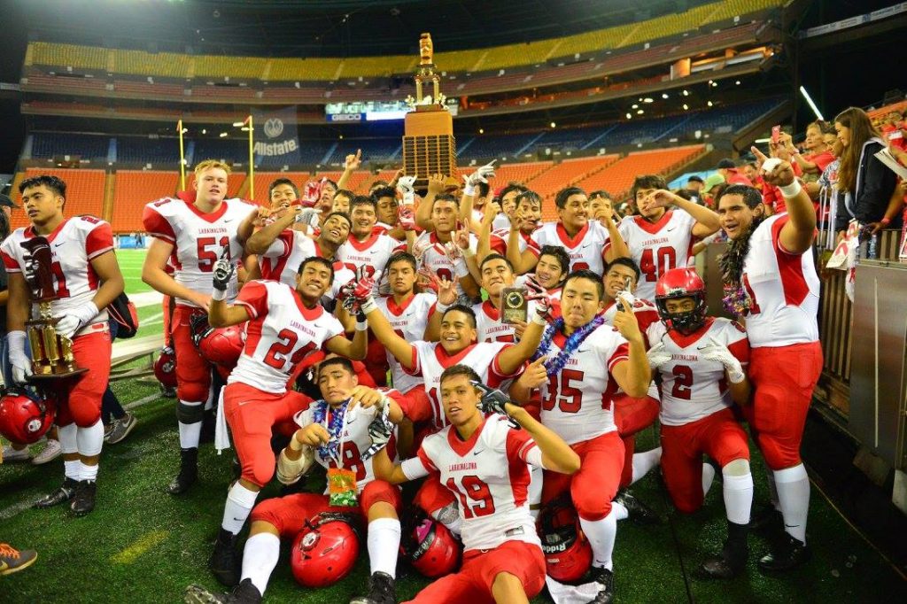 The Lunas celebrate with the Division II trophy on the field at Aloha Stadium last week. Photo by Rodney S. Yap