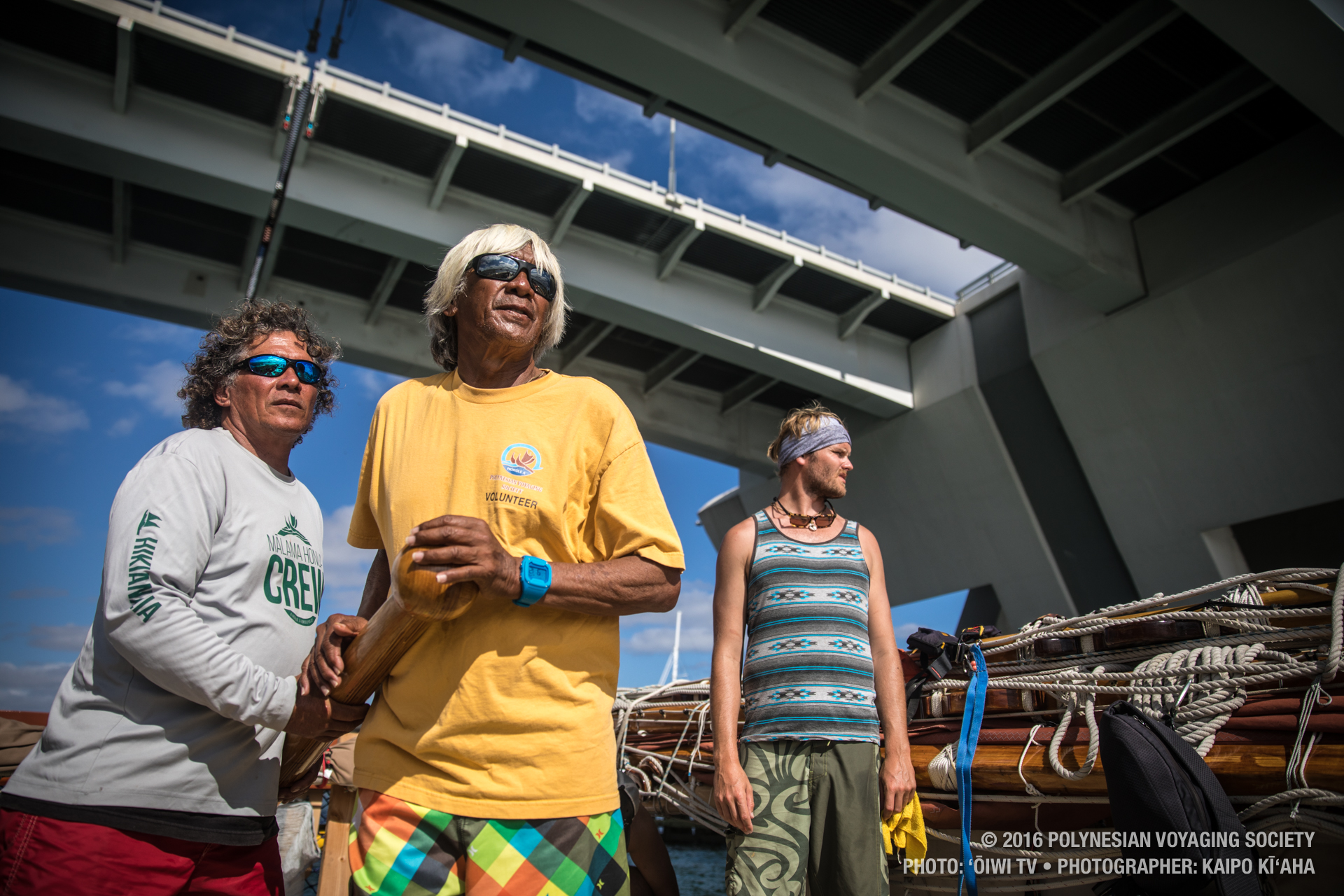 Keala Kai, Snake Ah Hee, and Zane Havens at the stern as we pass under a bridge. PC: ʻŌiwi TV/Kaipo Kīʻaha/2016 Polynesian Voyaging Society.