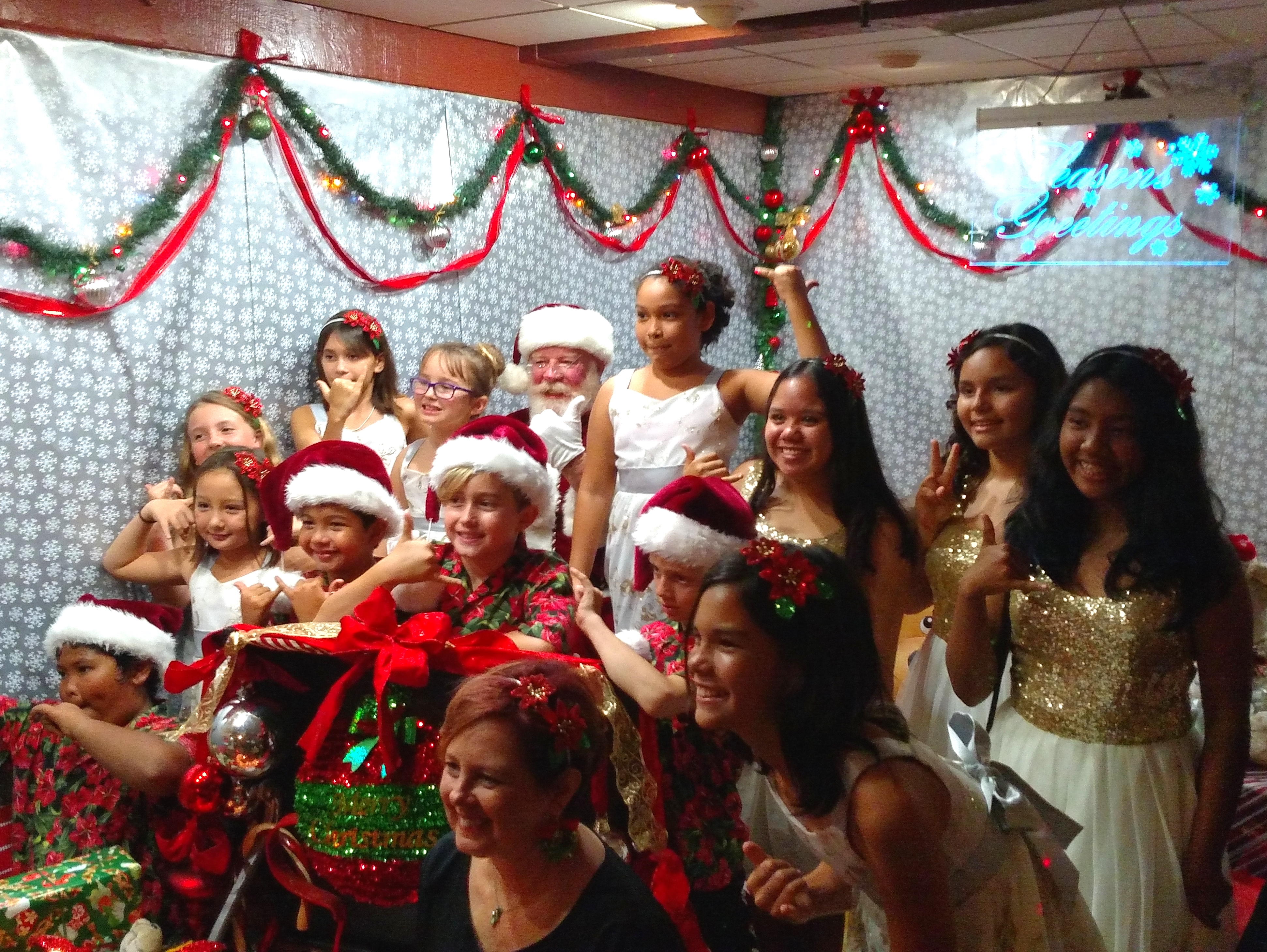 Sacred Hearts School Choir and Instructor Lori Ulman (bottom, center) with Santa. Courtesy photo.