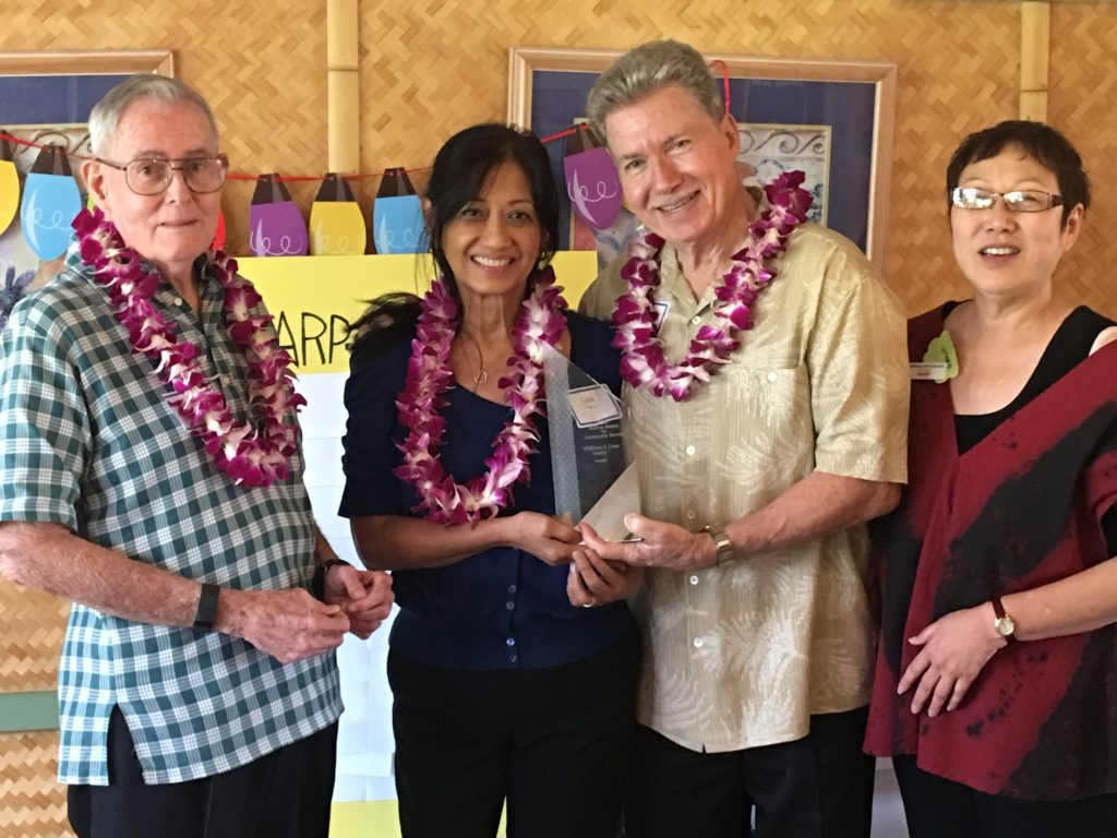 AARP Hawaii State Volunteer President Gerry Silva (left) presents the Andrus Award for community service in Hawaii to Lena and Bill Staton. AARP Hawaii State Director Barbara Kim Stanton looks on.